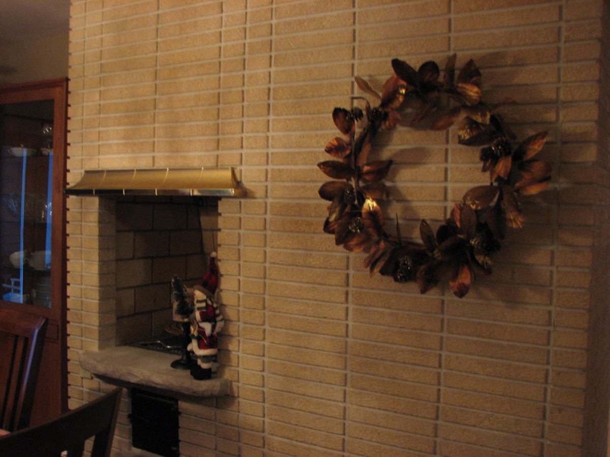 A cozy interior with a decorative wreath and a small shelf ornament.