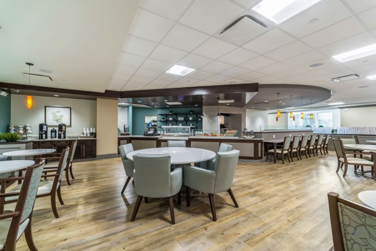 A modern dining area with a bar counter and seating arrangements.
