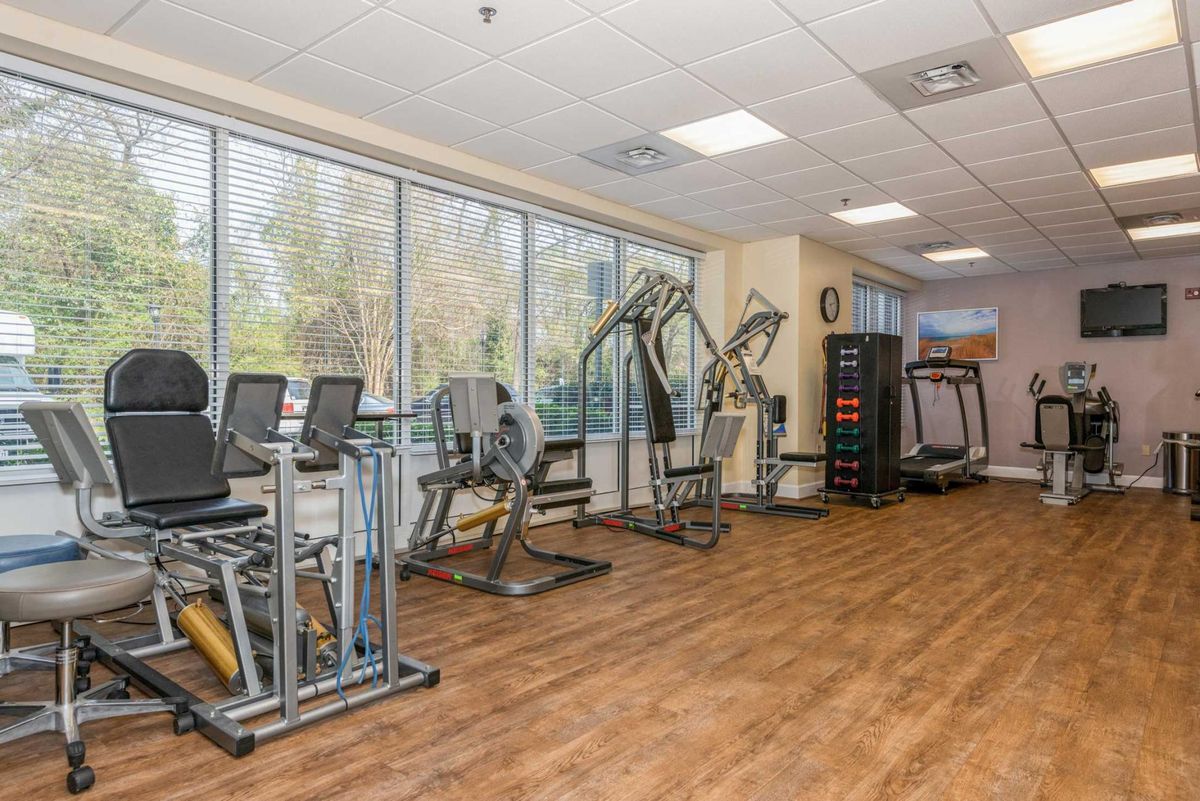 A well-equipped gym with various exercise machines and treadmills.