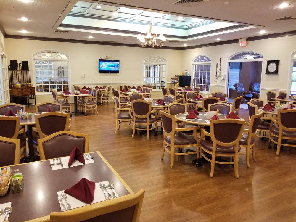 An empty restaurant dining area with neatly arranged tables and chairs.