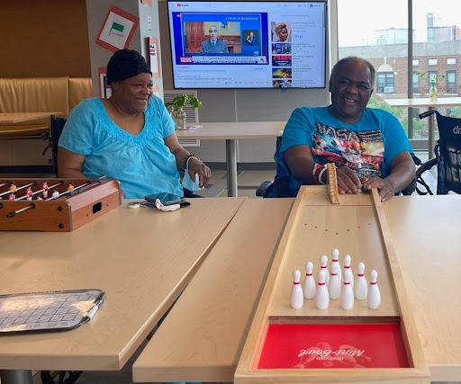 Two individuals enjoying a game indoors, fostering social interaction and community engagement.