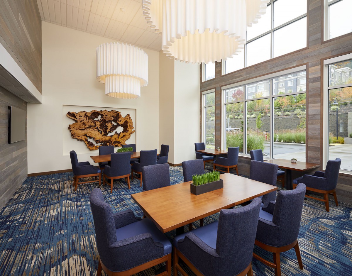 A modern dining area with large windows and elegant lighting.