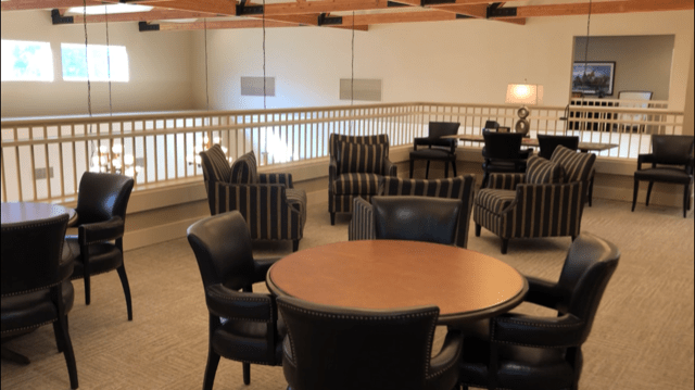 A cozy lounge area with comfortable seating and a round table.