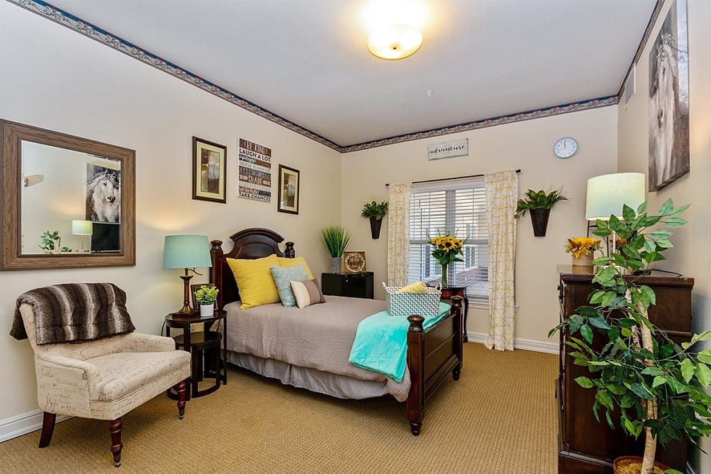 A cozy and well-decorated bedroom with stylish furniture, plants, and artwork.