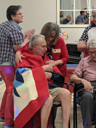 A joyful moment during a community celebration, where seniors share smiles and camaraderie.