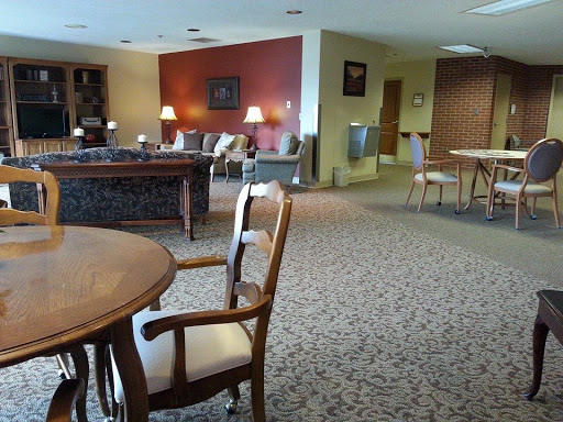 A spacious lounge area with comfortable seating and warm lighting.