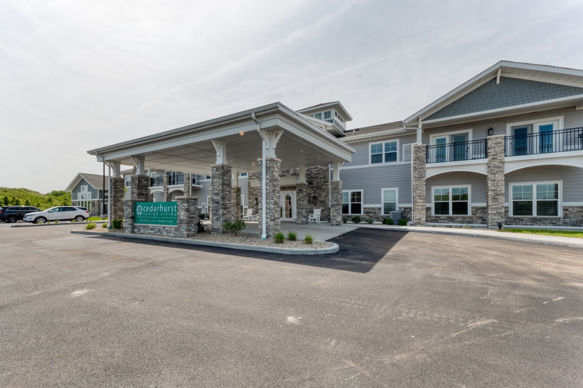 A modern building with a grand entrance and covered driveway.