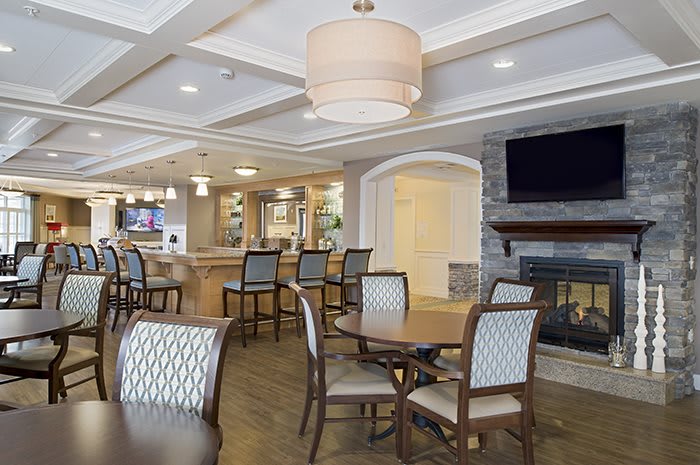 A modern dining area with elegant furnishings and lighting.