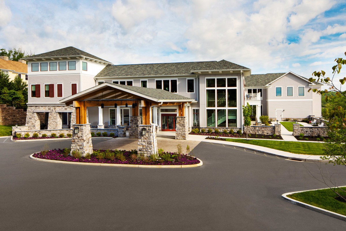 A modern residential building with a welcoming entrance and landscaped surroundings.