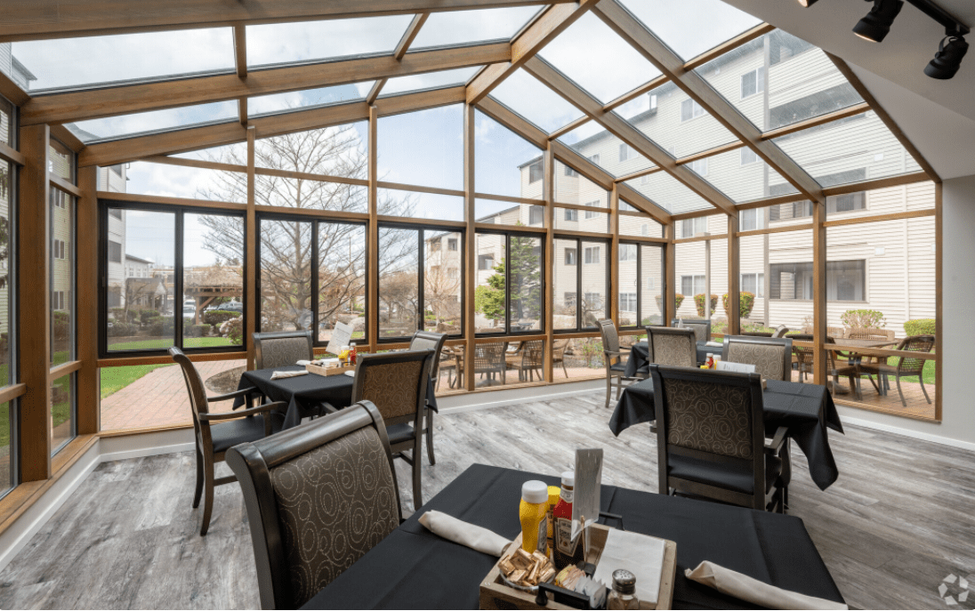 A bright, modern dining area with a glass roof offering a pleasant view.
