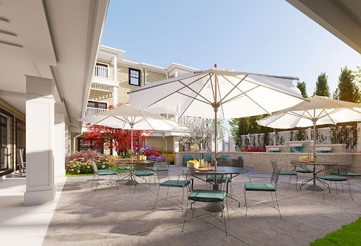 A serene outdoor patio area featuring umbrellas and comfortable seating, ideal for relaxation on a sunny day.