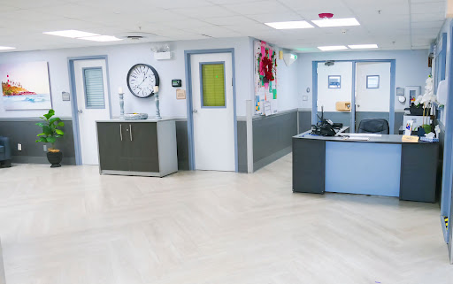 A clean and modern hospital reception area with a waiting space.