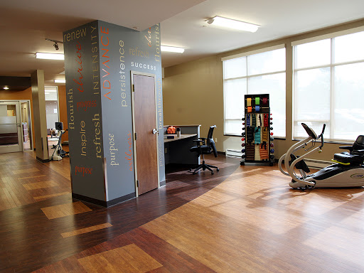 An inviting gym space featuring exercise equipment and a workspace, designed for fitness and well-being.