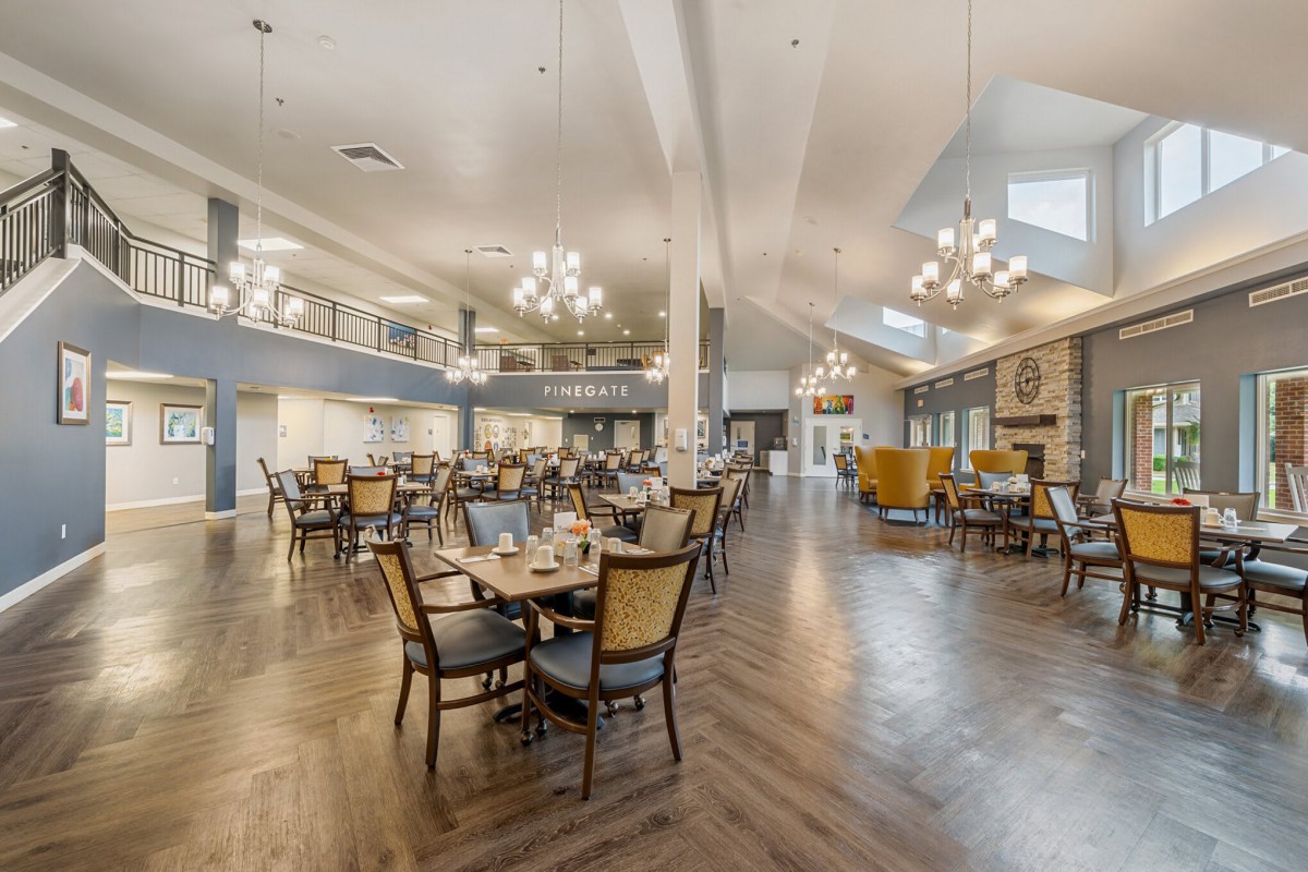 Spacious dining area with elegant chandeliers and comfortable seating.