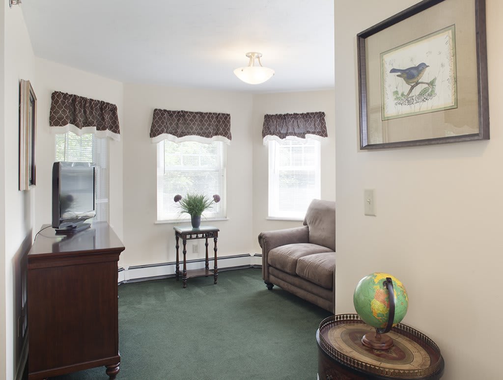 Cozy living room with a sofa and large windows.