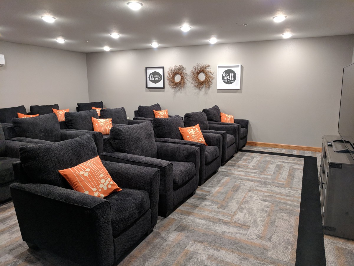 A cozy home theater with comfortable seating and modern decor.