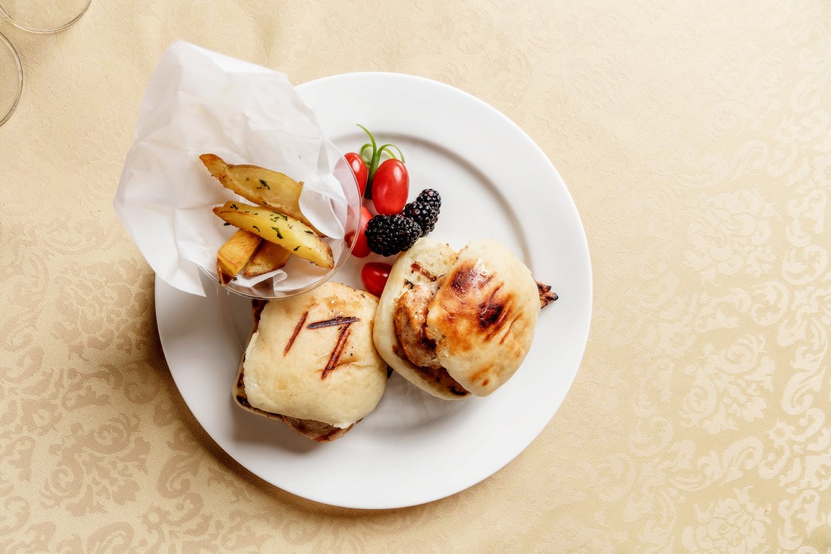 A plate of grilled sandwiches, a side of fries, and fresh berries.