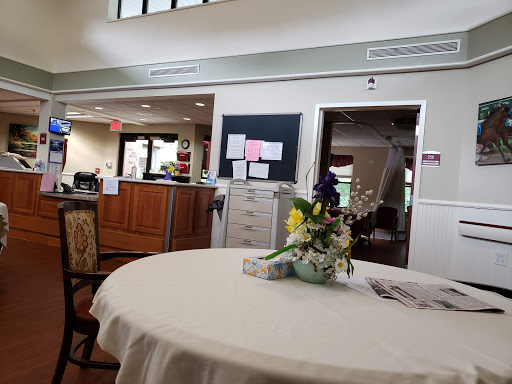 A welcoming lobby area featuring a beautifully arranged flower centerpiece on a table.