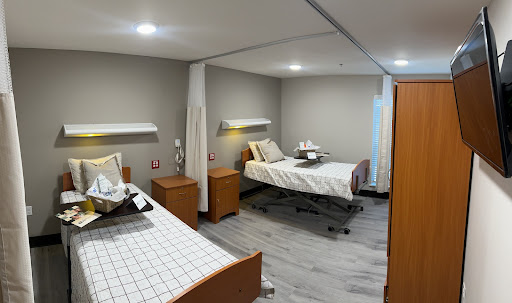 A spacious and modern hospital patient room designed for comfort and care.