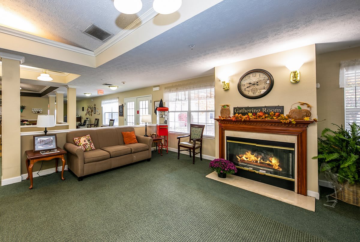 A cozy living room with a sofa, fireplace, and decorative elements.