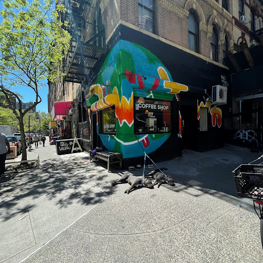 A vibrant mural adorns the exterior of a restaurant, adding color to the bustling city street.