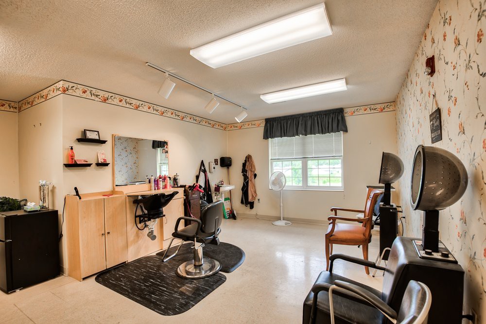 A well-equipped salon room with barber chairs and styling tools.