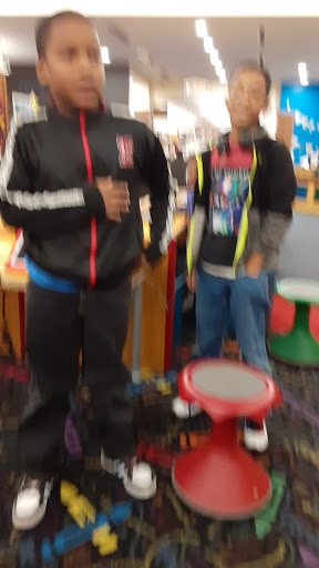 Two boys enjoying their time in a vibrant indoor play area.