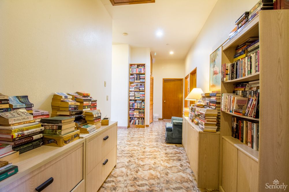 A home hallway lined with bookshelves filled with numerous books.