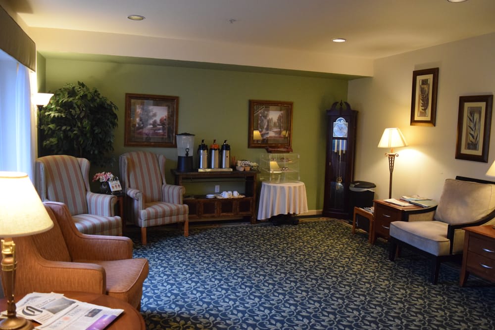 A cozy waiting room with comfortable seating and a coffee station.
