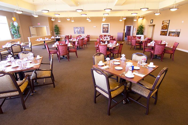 A spacious dining room with neatly set tables and chairs, ready for guests.