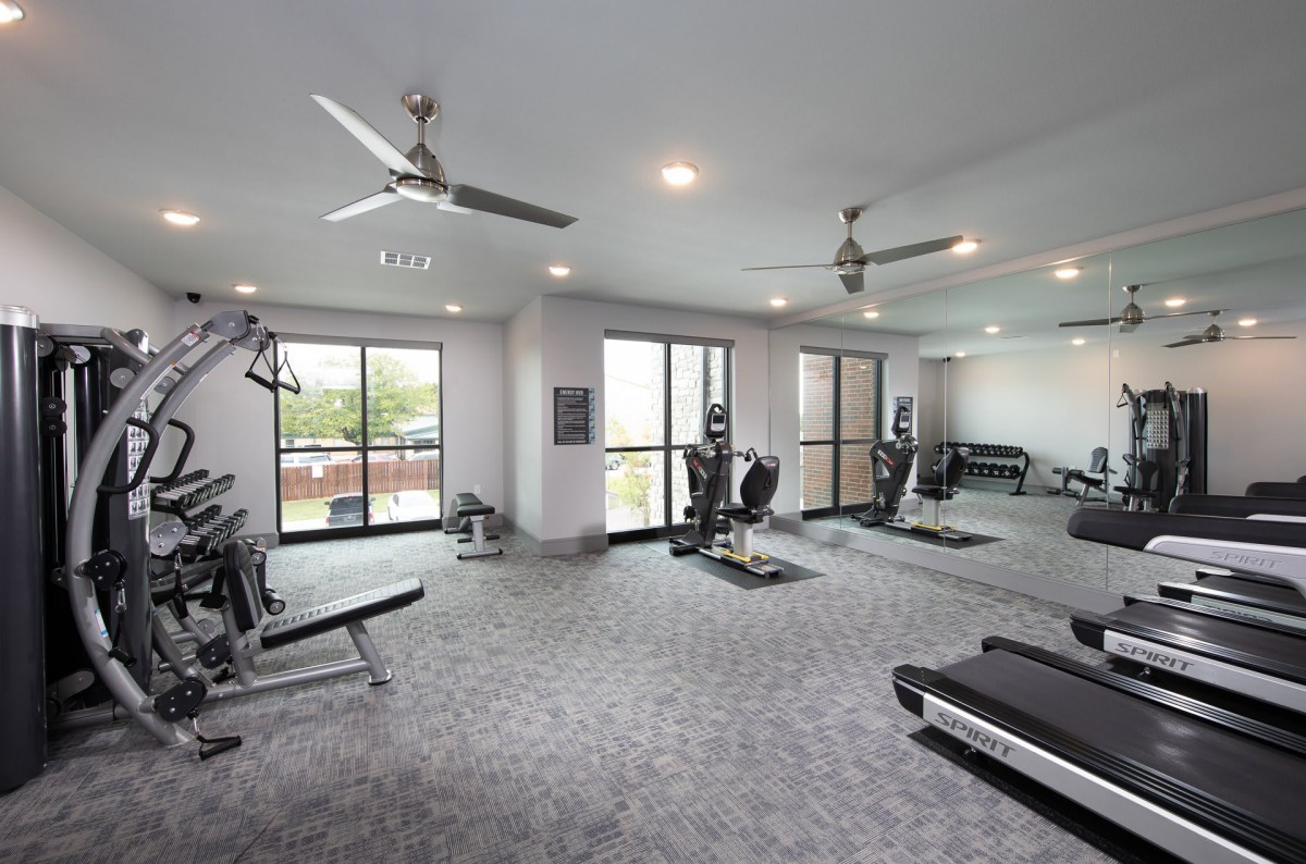 A modern gym equipped with treadmills, weights, and other exercise machines.