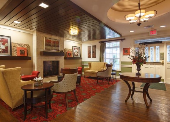 A cozy living room with elegant furniture, a fireplace, and warm lighting.