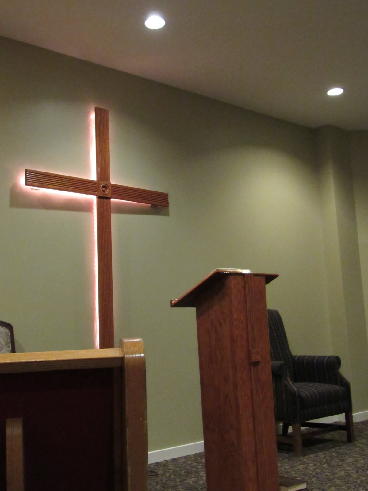 Interior of a church featuring a cross and pulpit.