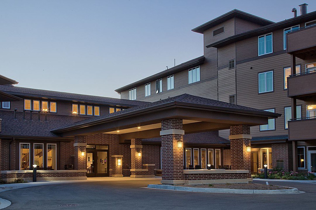 Exterior view of a hotel entrance during evening hours.