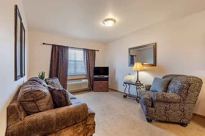 A cozy living room with comfortable seating and a television.