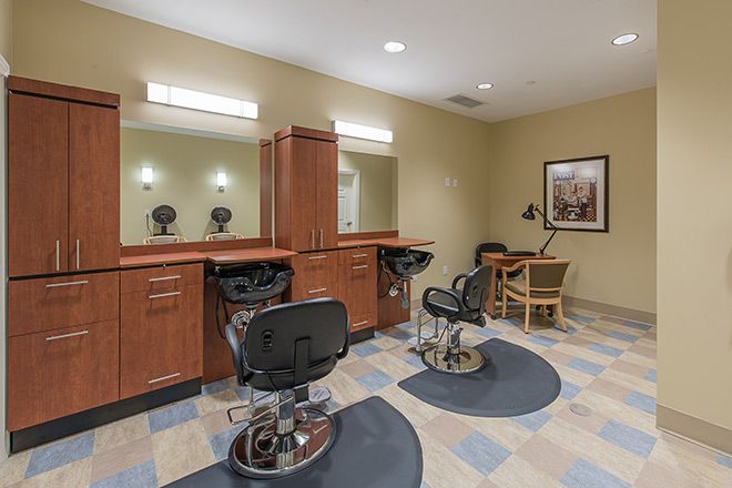 A well-lit beauty salon interior with modern chairs and mirrors.