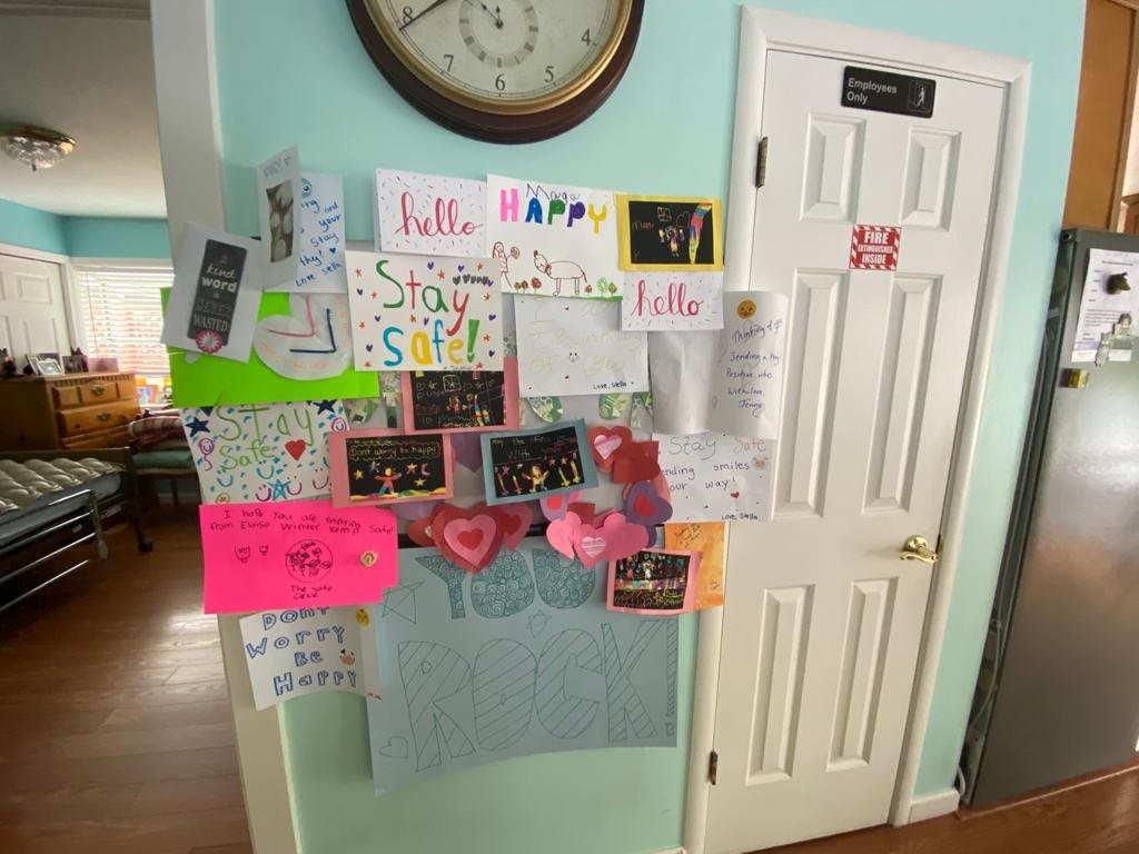 A door adorned with a variety of colorful handmade cards and notes celebrating a birthday.