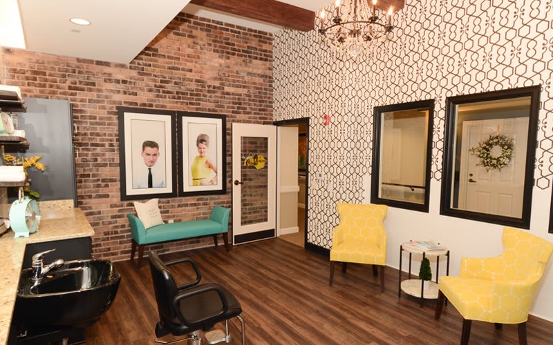 A stylish salon waiting area with vibrant decor and comfortable seating.