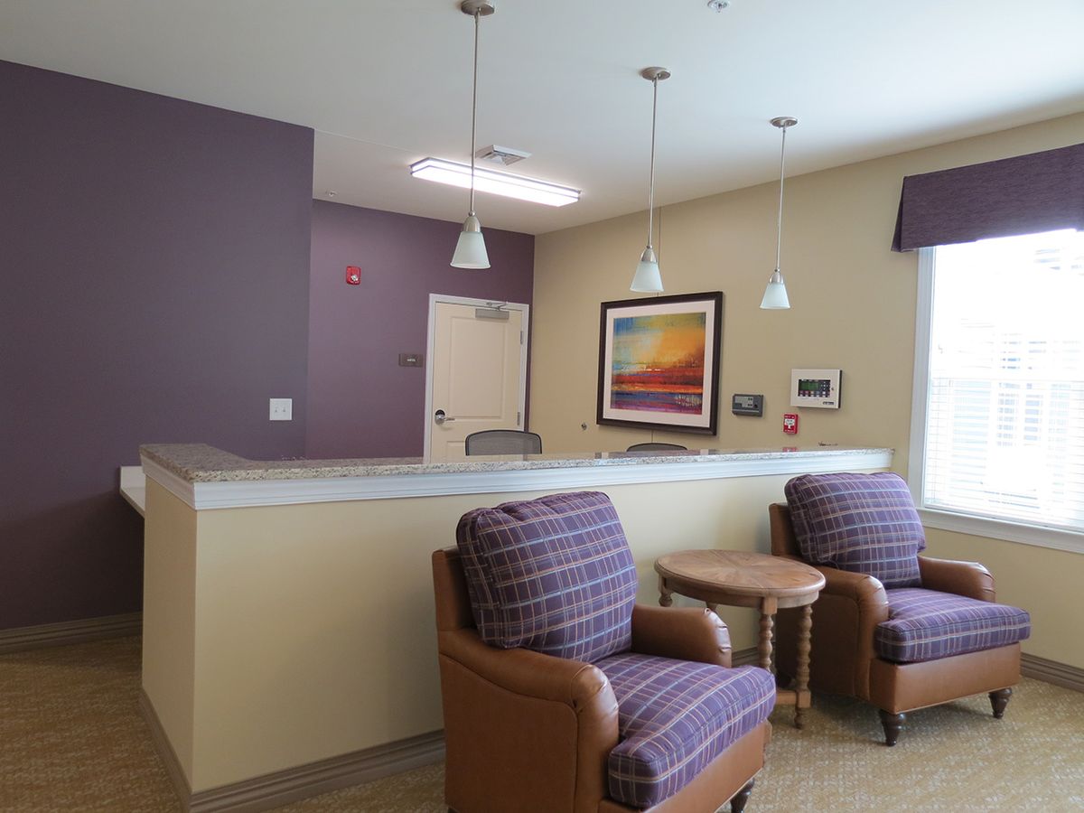 A cozy waiting room with comfortable chairs and soft lighting.