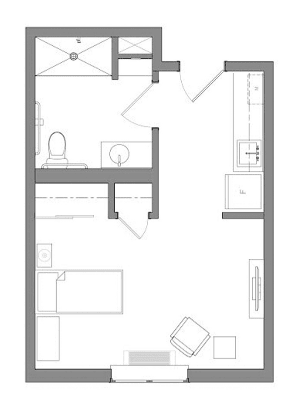 A compact apartment floor plan featuring a bedroom, bathroom, and kitchen area.