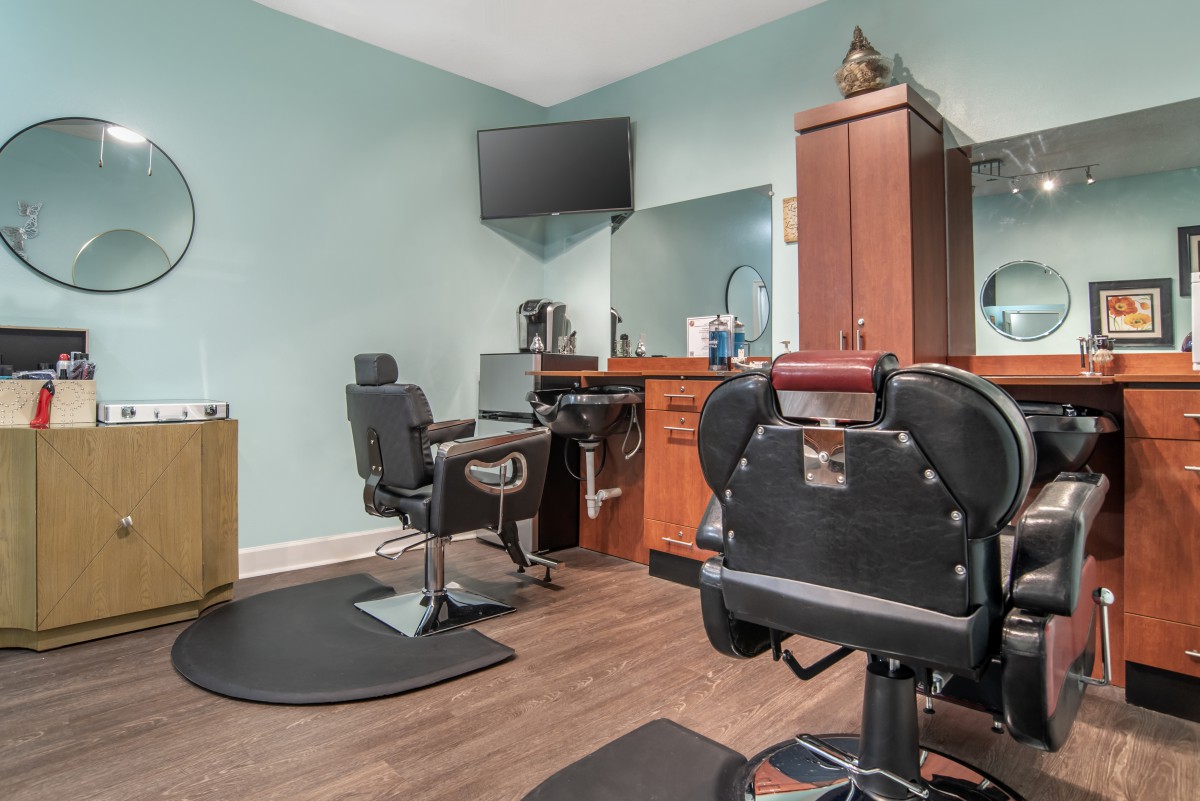 A cozy barbershop interior with chairs and hair styling tools arranged neatly.
