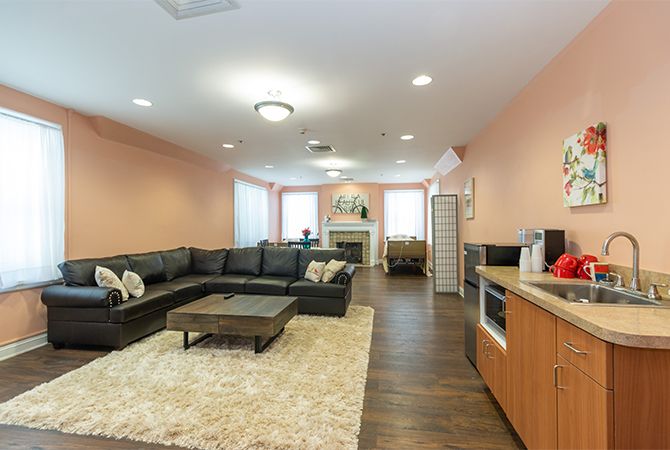A modern living room with a spacious sectional sofa and cozy fireplace.
