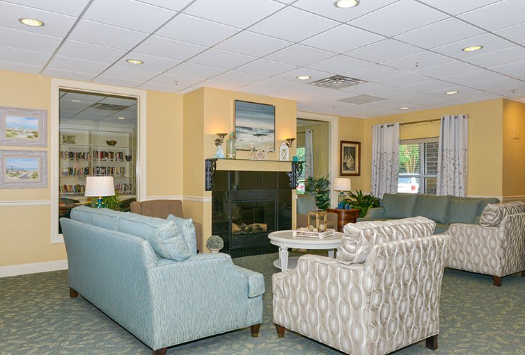 A cozy living room with a fireplace, sofas, and stylish decor.