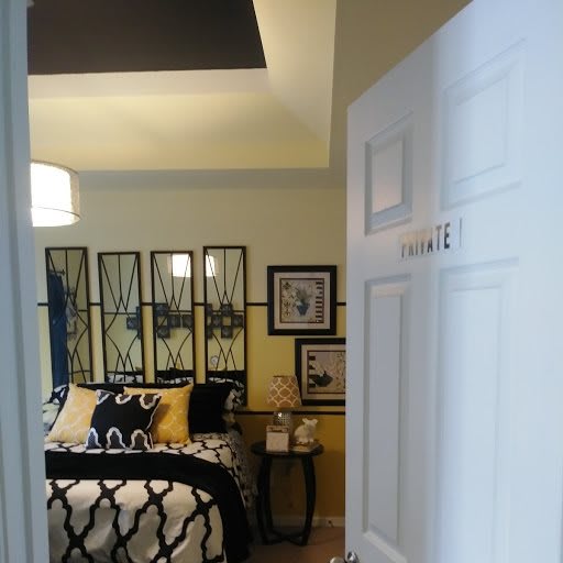 A stylishly decorated bedroom with modern furnishings and artistic wall decor.