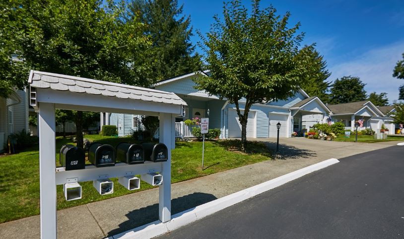 A suburban residential street with mailboxes and houses.
