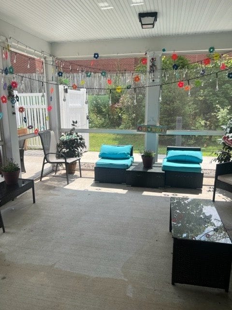 A cozy patio with comfortable seating and a view of the garden.