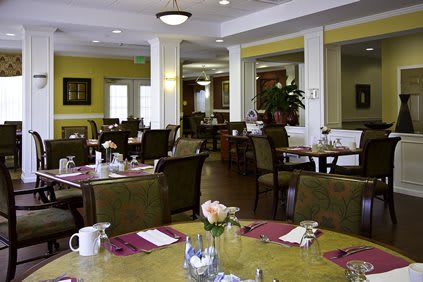 A cozy restaurant dining area with tables and chairs set for service.