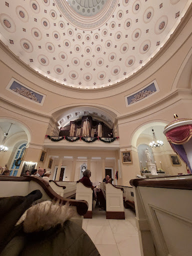 An elegant interior featuring a stunning dome and ornate architectural details.