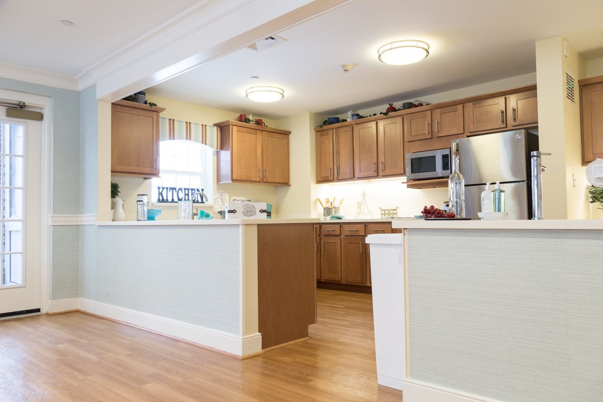 Modern kitchen with wooden cabinets and appliances.