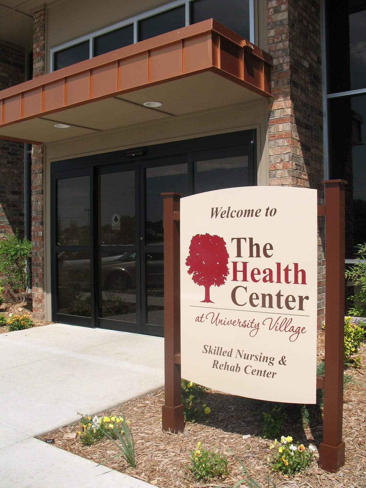 Entrance to The Health Center with a welcoming sign.
